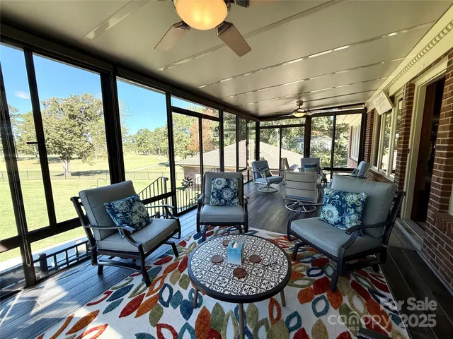 a living room with furniture and a floor to ceiling window