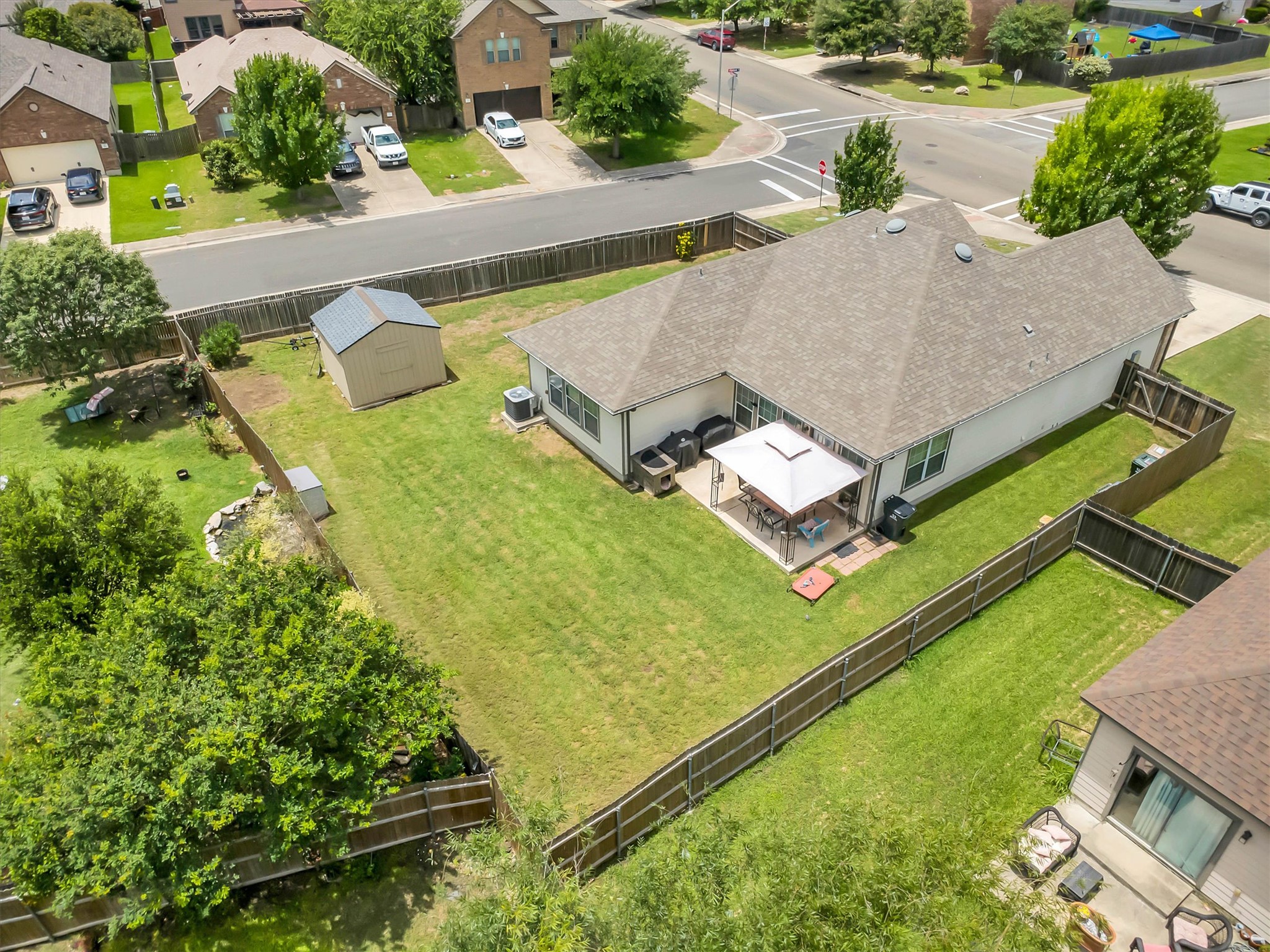 460 Waterleaf Boulevard Kyle, TX 78640 - Photo 27 of 30 An aerial perspective showcases a well-maintained yard and an inviting rear patio, perfect for outdoor living.