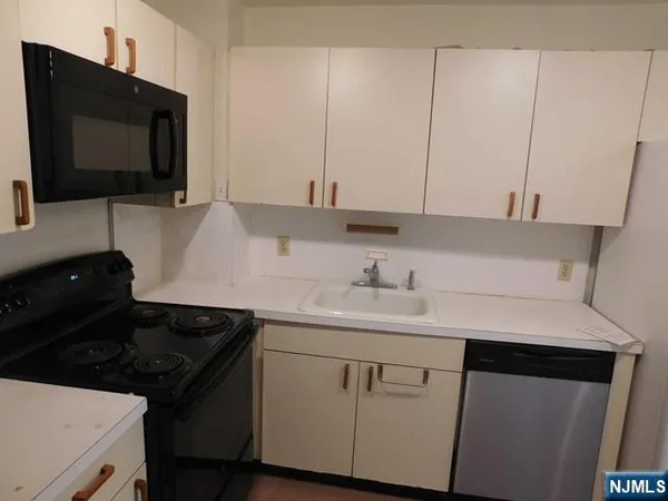 a kitchen with a sink and a stove top oven