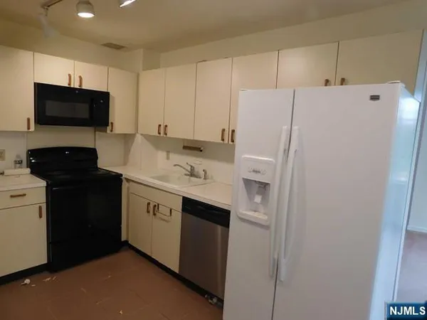 a utility room with cabinets washer and dryer