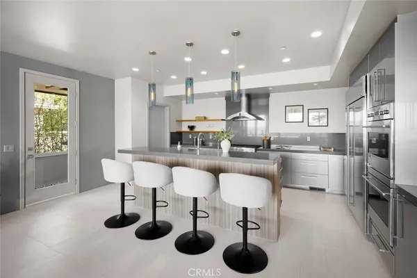 a kitchen with stainless steel appliances granite countertop a stove a sink and a granite counter tops