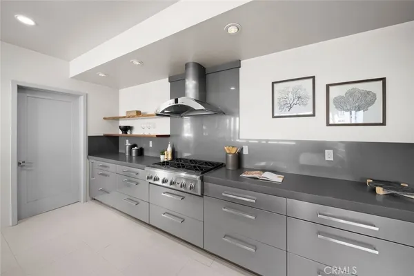 a kitchen with stainless steel appliances granite countertop a sink and a stove