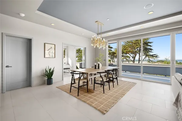 a view of a dining room with furniture and chandelier