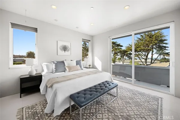 a spacious bathroom with a double vanity sink toilet mirror and shower