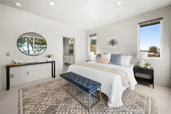 a spacious bedroom with a bed and a flat screen tv