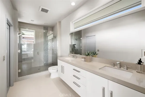 a bedroom with a bed and a potted plant