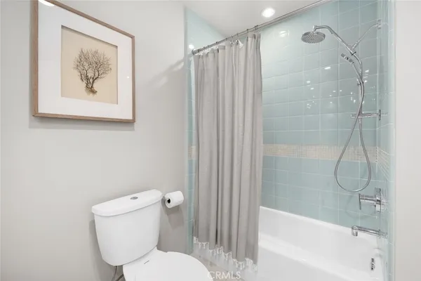 an aerial view of residential houses with outdoor space and ocean view