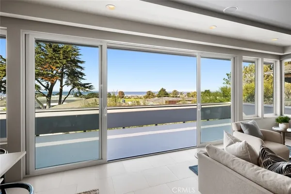 a outdoor living room with a large window and furniture