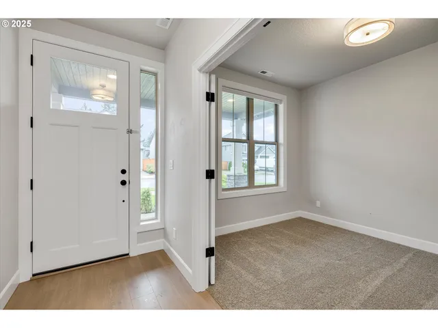 an empty room with windows and closet