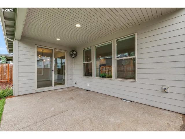 a view of a house with a yard and potted plants