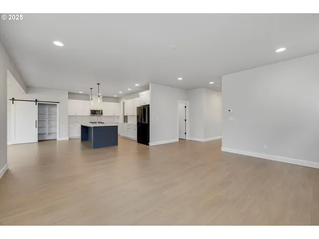 a kitchen with kitchen island a sink stainless steel appliances and cabinets