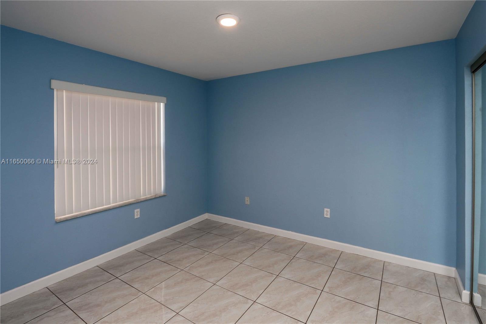 23935 Southwest 108th Place Homestead, FL 33032 - Photo 14 of 30 a view of an empty room with window