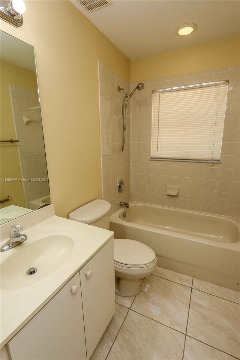 23935 Southwest 108th Place Homestead, FL 33032 - Photo 16 of 30 a bathroom with a sink a toilet and shower