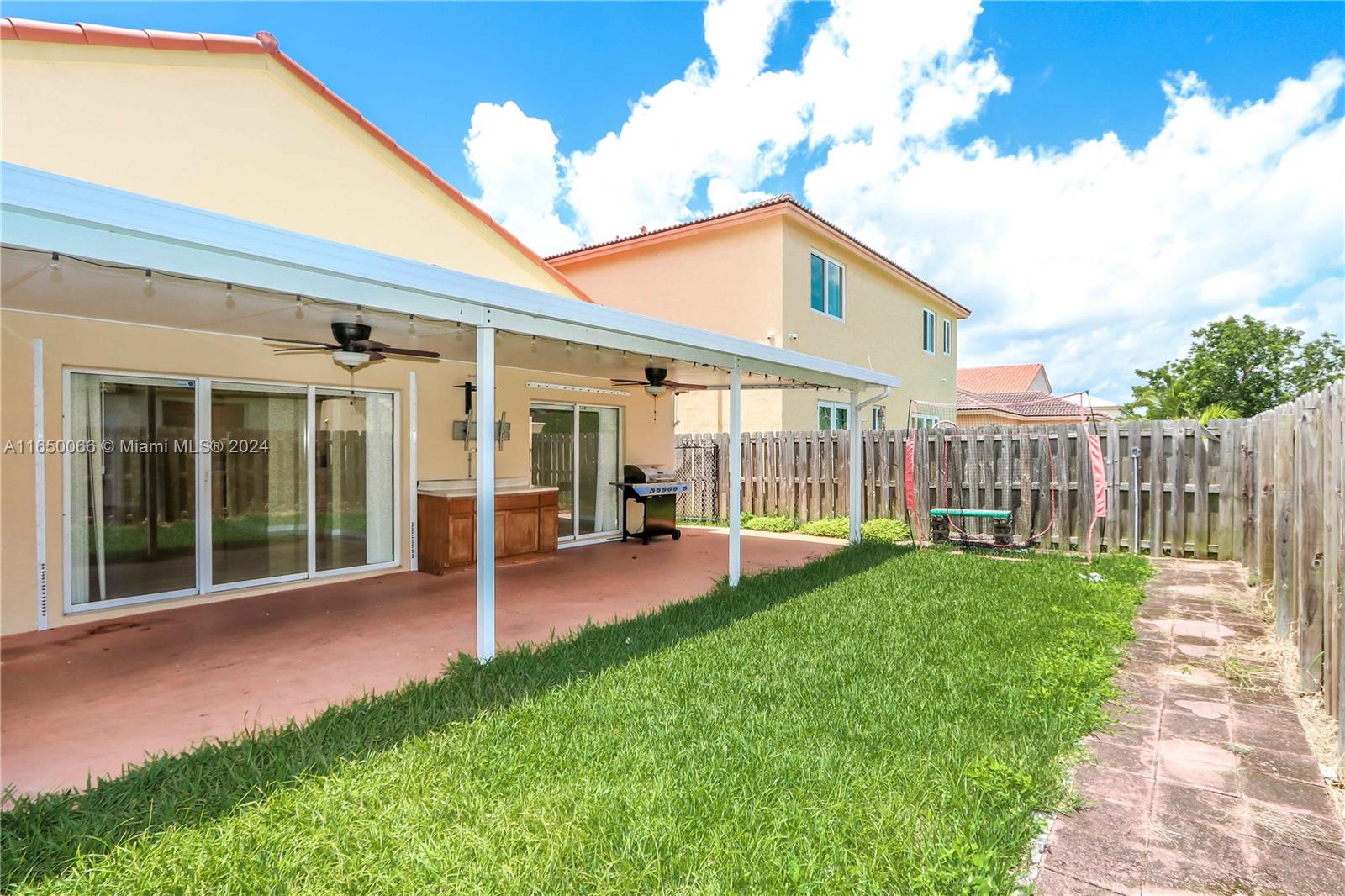 23935 Southwest 108th Place Homestead, FL 33032 - Photo 19 of 30 a view of a house with backyard porch and garden