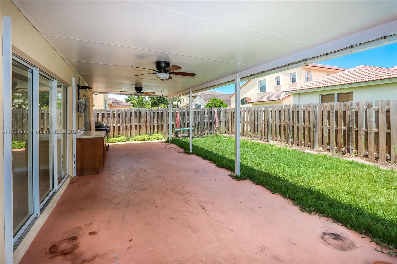 23935 Southwest 108th Place Homestead, FL 33032 - Photo 20 of 30 a view of a porch with a big yard and plants