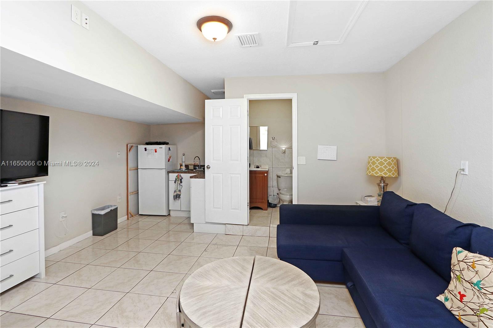 23935 Southwest 108th Place Homestead, FL 33032 - Photo 23 of 30 a living room with furniture and a flat screen tv