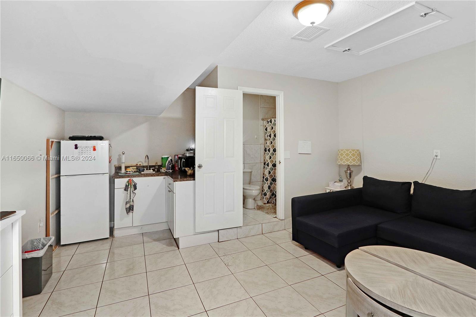 23935 Southwest 108th Place Homestead, FL 33032 - Photo 24 of 30 a living room with furniture and a refrigerator