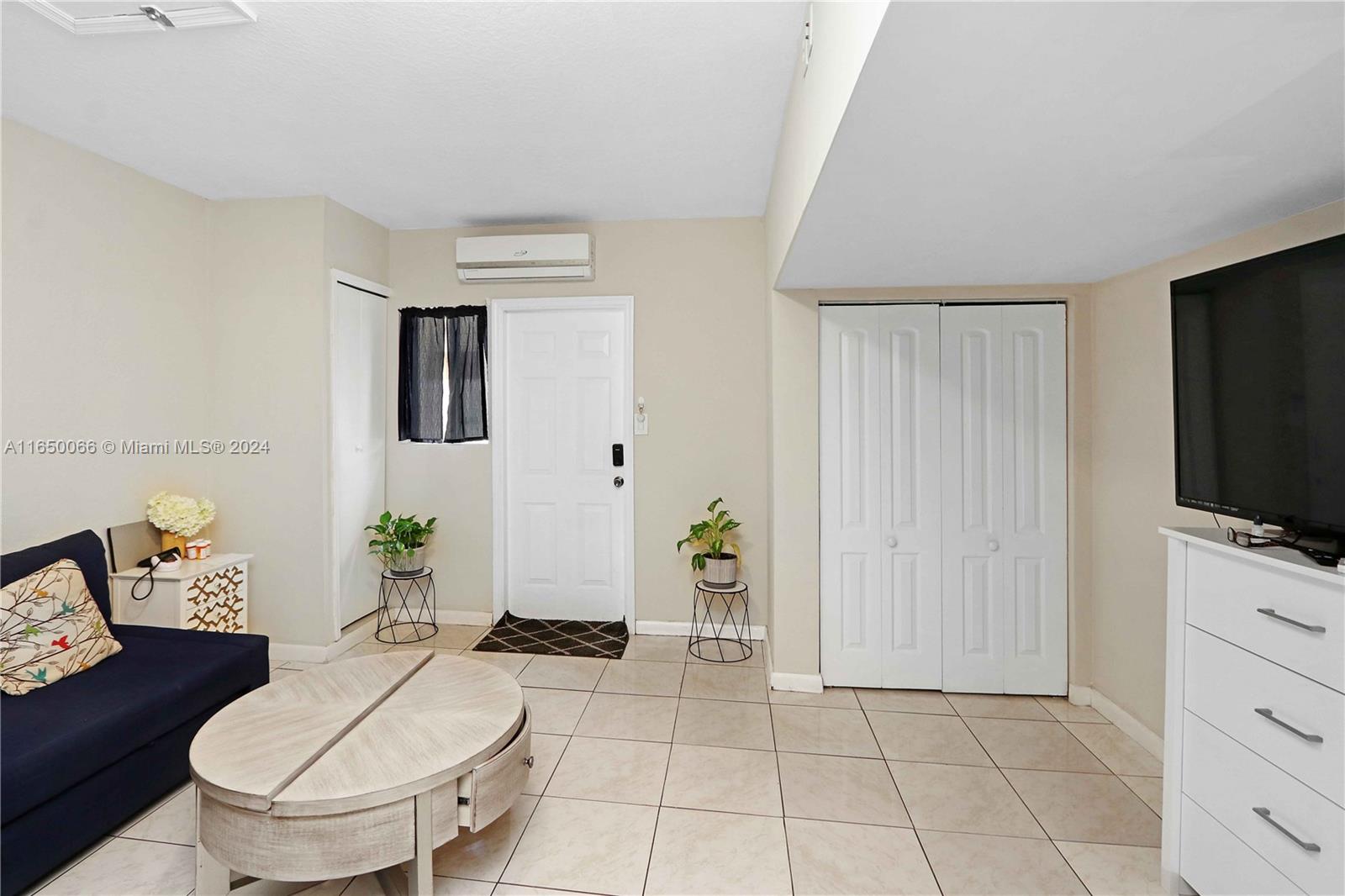 23935 Southwest 108th Place Homestead, FL 33032 - Photo 26 of 30 a living room with furniture and a flat screen tv