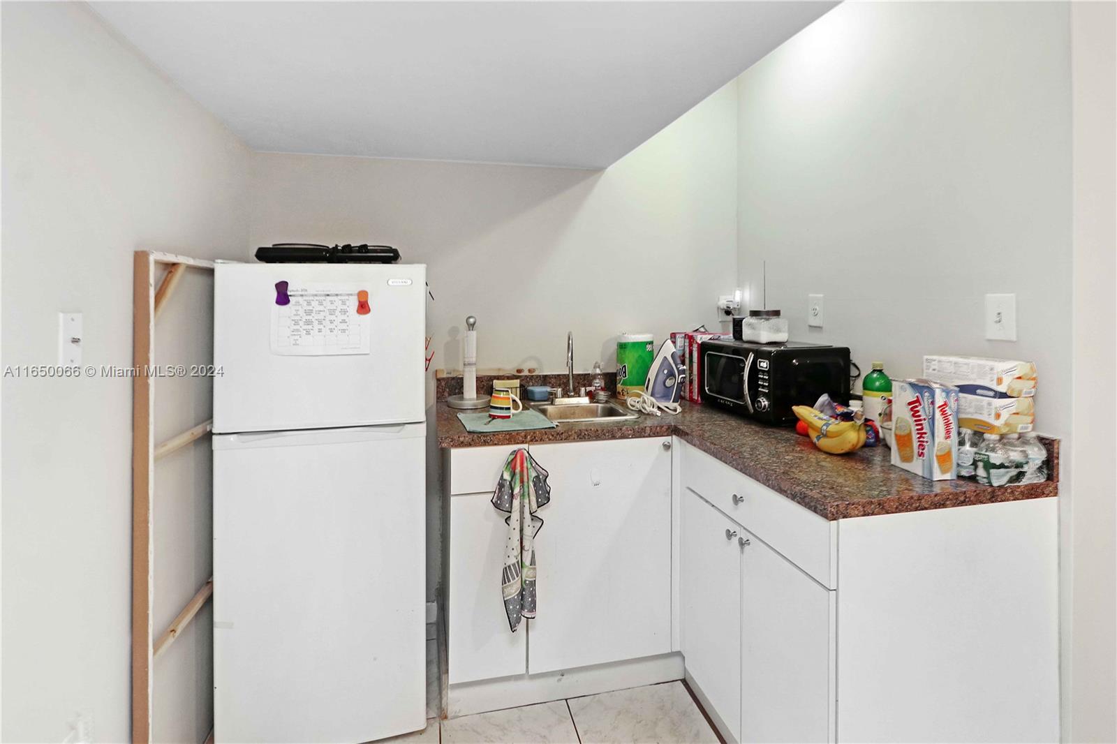 23935 Southwest 108th Place Homestead, FL 33032 - Photo 27 of 30 a white refrigerator freezer sitting in a kitchen