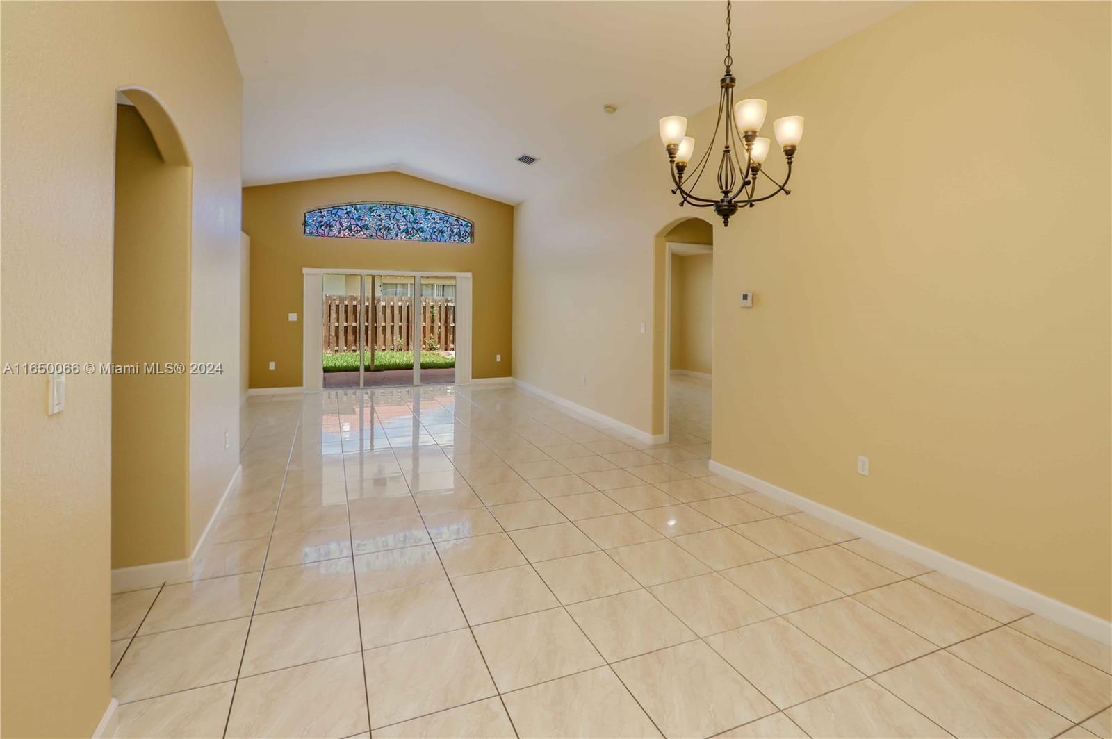 23935 Southwest 108th Place Homestead, FL 33032 - Photo 4 of 30 a view of a hallway with a chandelier