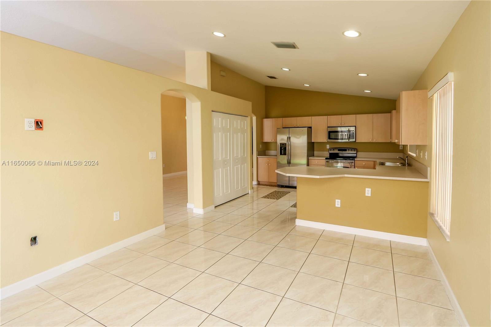 23935 Southwest 108th Place Homestead, FL 33032 - Photo 9 of 30 a view of kitchen with stainless steel appliances kitchen island granite countertop a refrigerator and cabinets