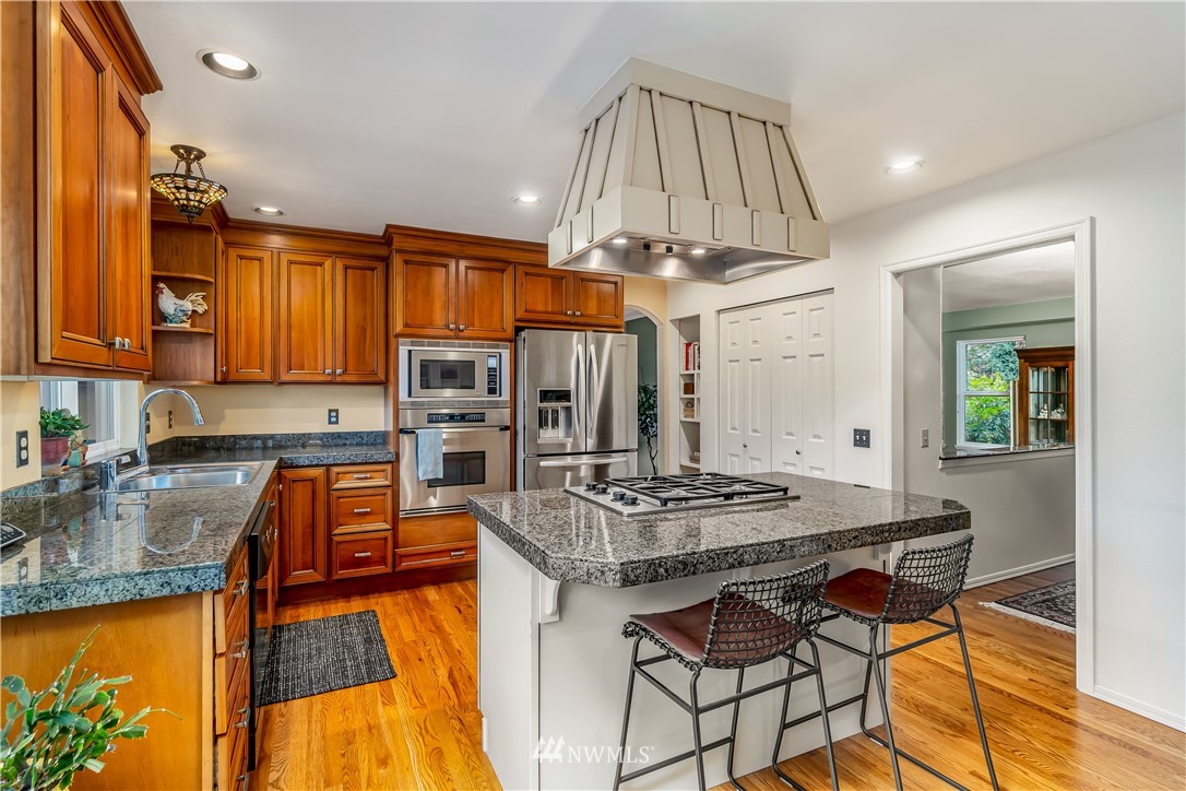23701 3rd Place West Bothell, WA 98021 - Photo 11 of 31 a kitchen with stainless steel appliances granite countertop a stove top oven a sink and cabinets