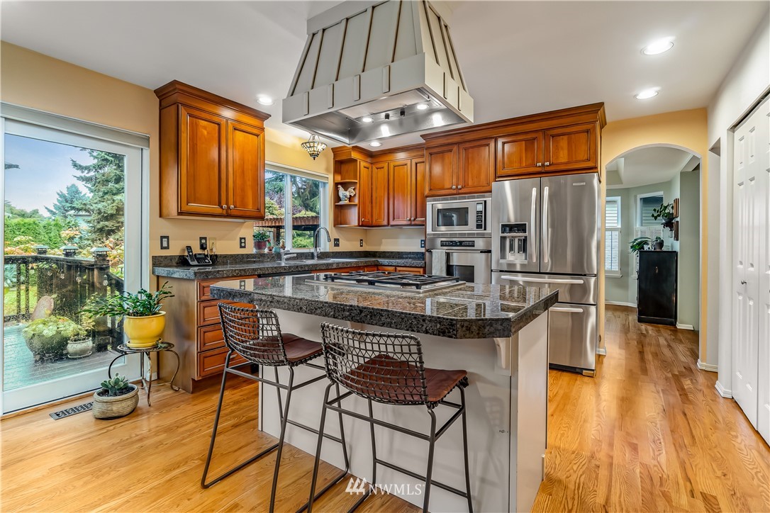 23701 3rd Place West Bothell, WA 98021 - Photo 12 of 31 a kitchen with stainless steel appliances granite countertop a stove and refrigerator