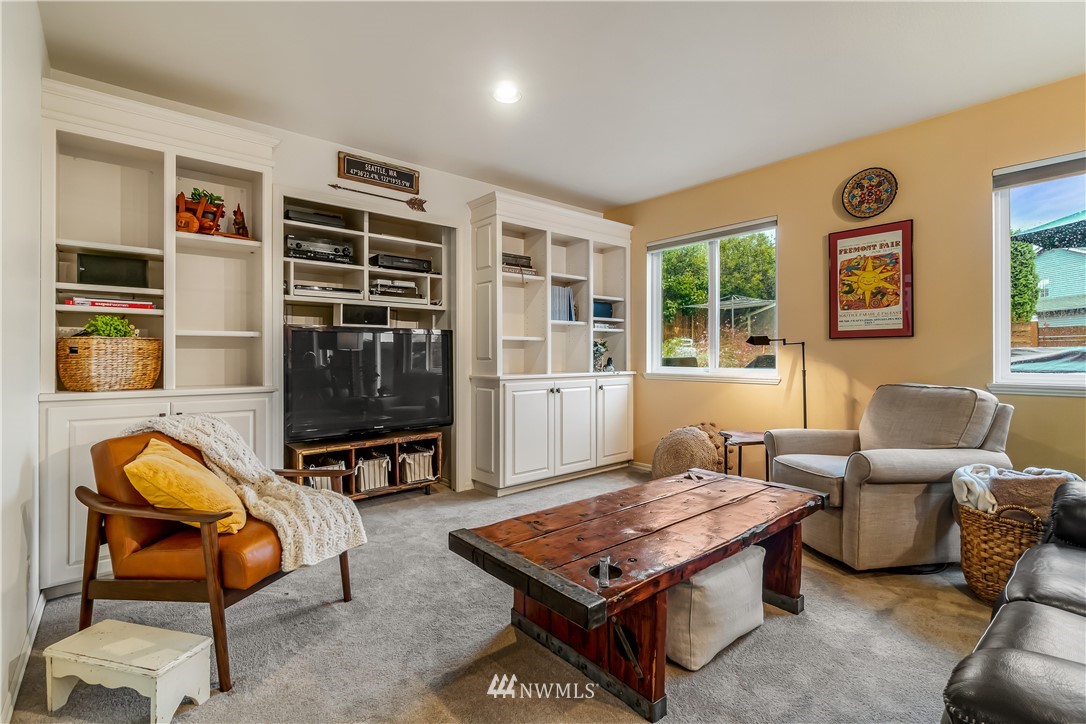 23701 3rd Place West Bothell, WA 98021 - Photo 16 of 31 a living room with furniture a flat screen tv and a window
