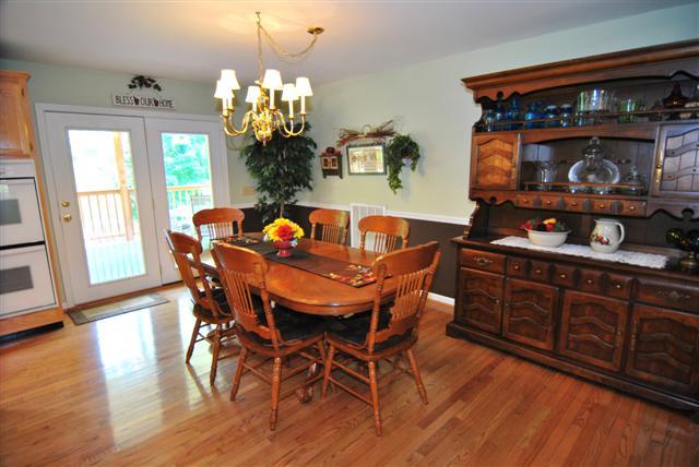 276 Murrell Road Dickson, TN 37055 - Photo 7 of 20 The dining room is such an inviting space to entertain or to enjoy an everyday meal, with its beautiful hardwoods, classic chandelier light fixture, chair rail, and lots of natural light from the glass door leading to the back patio.