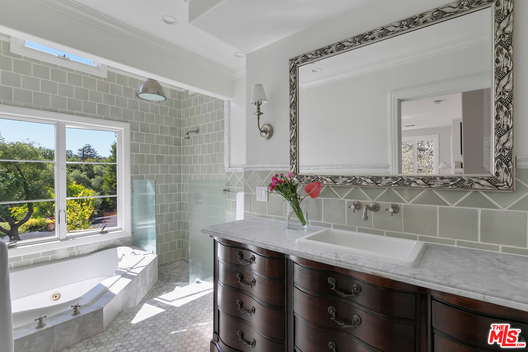 534 Lakeview Road Pasadena, CA 91105 - Photo 19 of 34 a bathroom with a granite countertop sink a toilet a mirror and shower