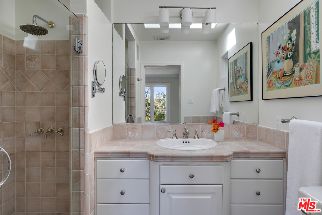 534 Lakeview Road Pasadena, CA 91105 - Photo 22 of 34 a bathroom with a sink and a mirror
