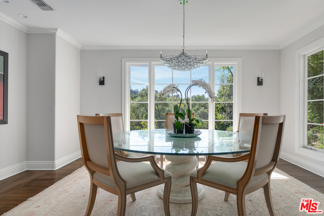 534 Lakeview Road Pasadena, CA 91105 - Photo 8 of 34 a dining room with furniture a chandelier and wooden floor