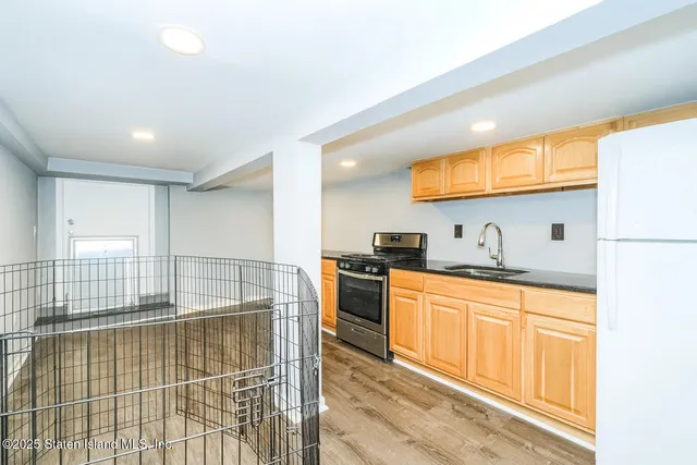 a kitchen with stainless steel appliances granite countertop a sink and cabinets