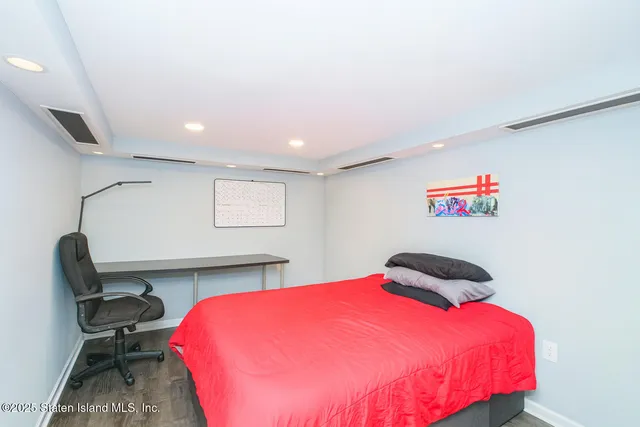 a bedroom with a bed and a chair