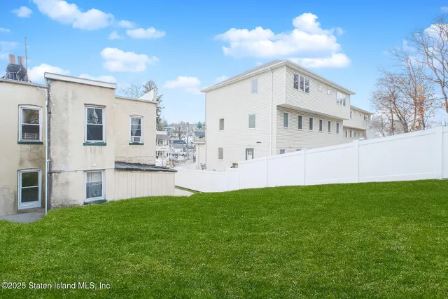 a view of house with backyard and garden