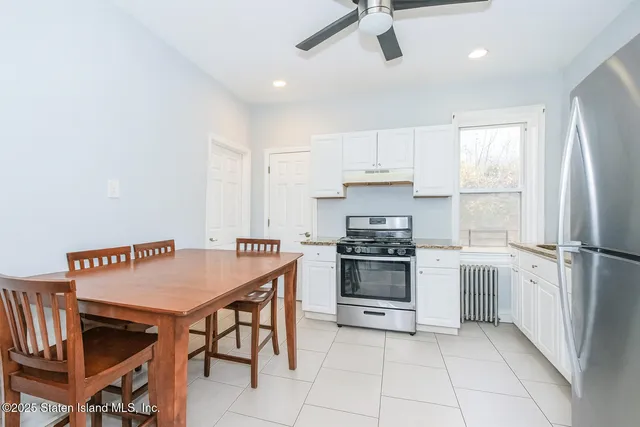 a kitchen with stainless steel appliances granite countertop a stove refrigerator and a sink