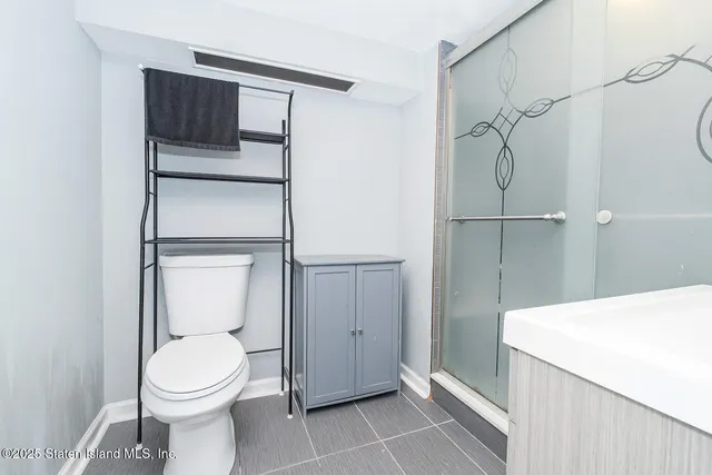 a bathroom with a toilet sink and shower