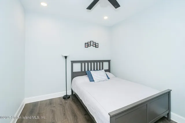 a bedroom with a bed and ceiling fan