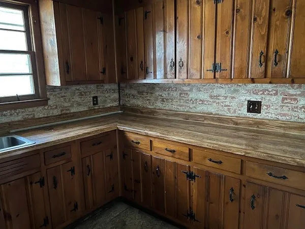 a kitchen with a refrigerator and a stove