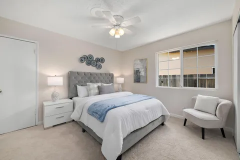 a bedroom with a bed couch and window
