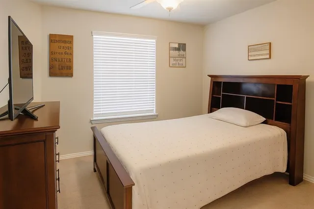 a bedroom with a bed and a window