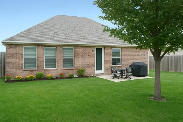 a view of a house with backyard sitting area and garden