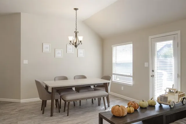 a dining room with furniture and window