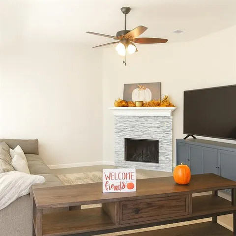 a living room with furniture and a fireplace