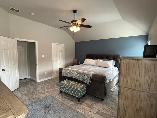 a bedroom with a bed and a chandelier