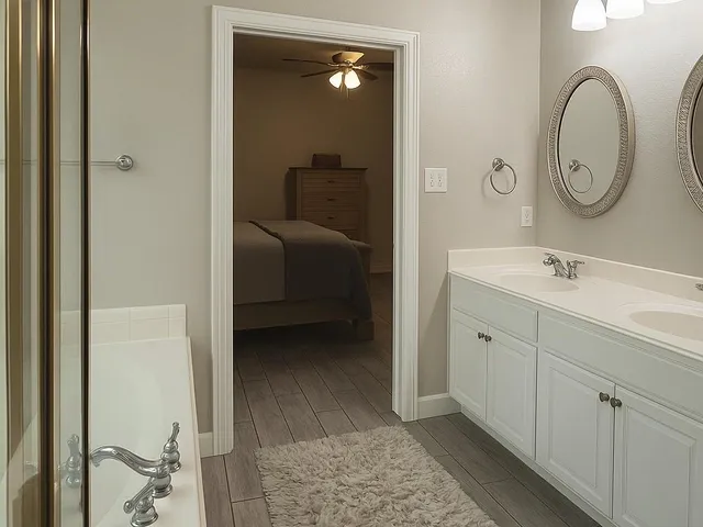 a en suite bathroom with a sink and a mirror