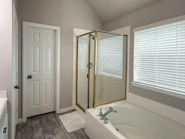 a bathroom with a bathtub and a shower