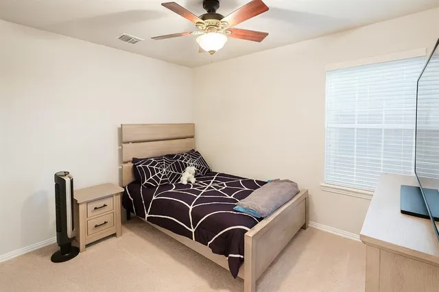 a bedroom with furniture and a window