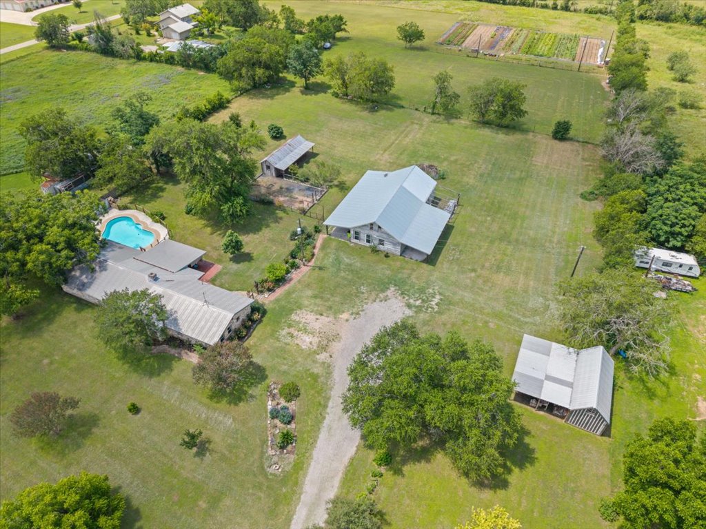 2421 Post Oak Road Webberville, TX 78653 - Photo 33 of 36 This is an amazing opportunity! You can see the main house with the pool, the long driveway, the huge workshop, and the secondary barns all neatly spread out on a gorgeous tract of land.