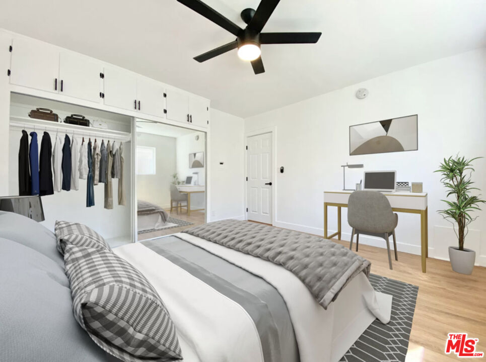 3824 Keystone Avenue, Unit 2 Culver City, CA 90232 - Photo 6 of 10 a bedroom with a bed and a chandelier